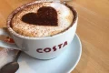 Cup of Costa coffee with chocolate-sprinkle heart