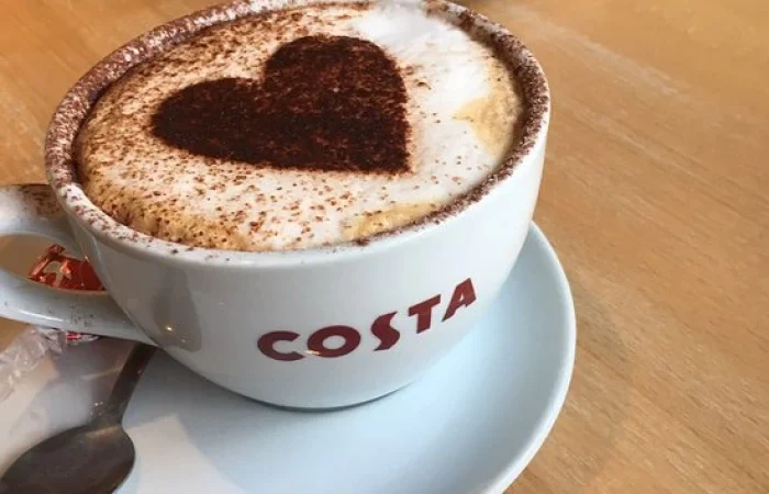 Cup of Costa coffee with chocolate-sprinkle heart
